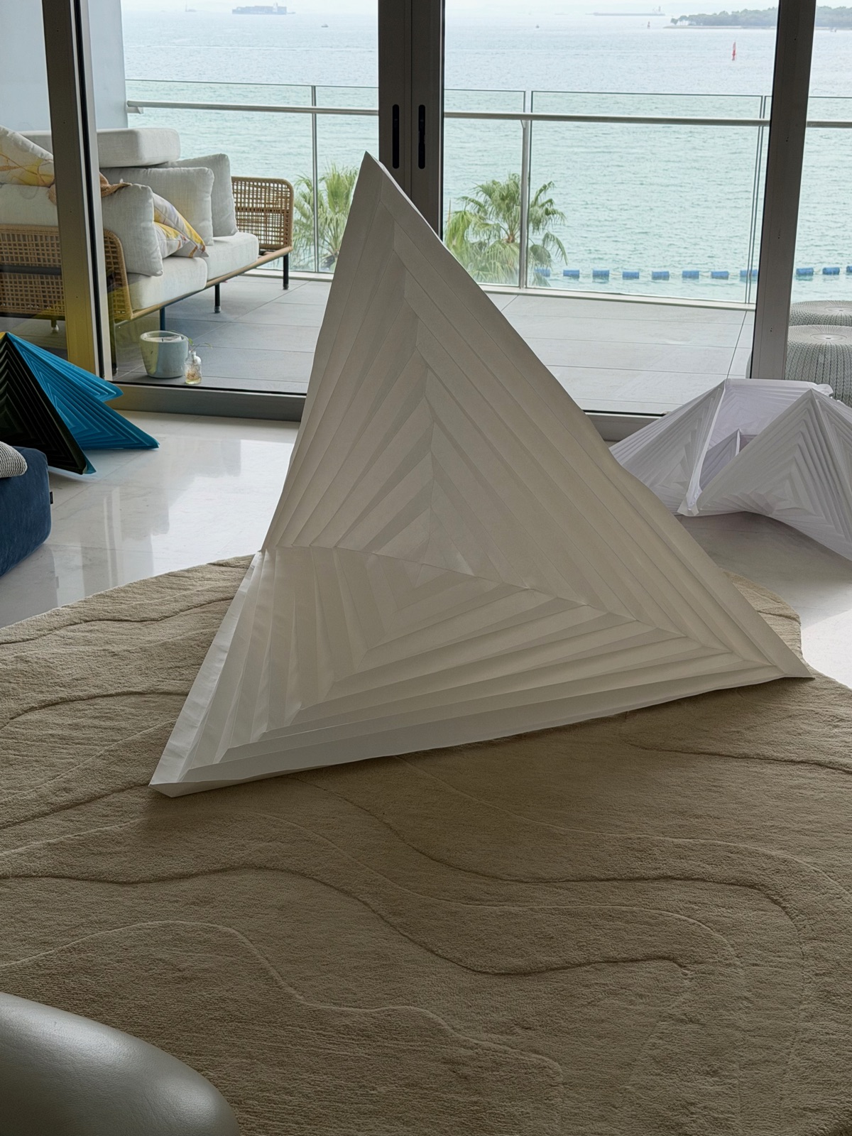 Large folded hypar in front of the sea